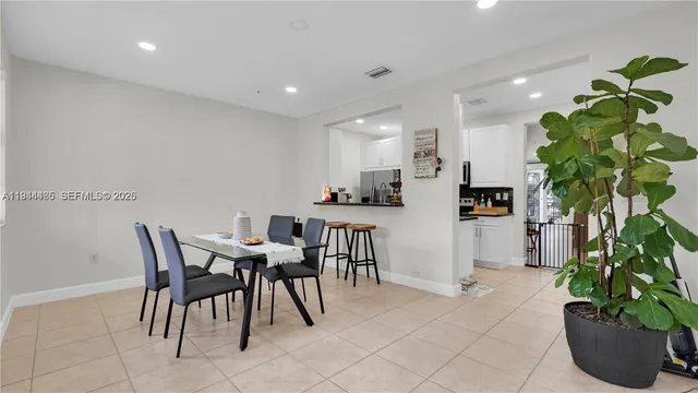 a view of a dining room with furniture and a potted plant