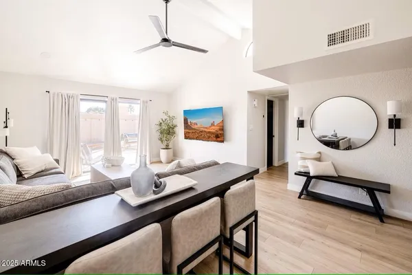 a living room with furniture a window and a table