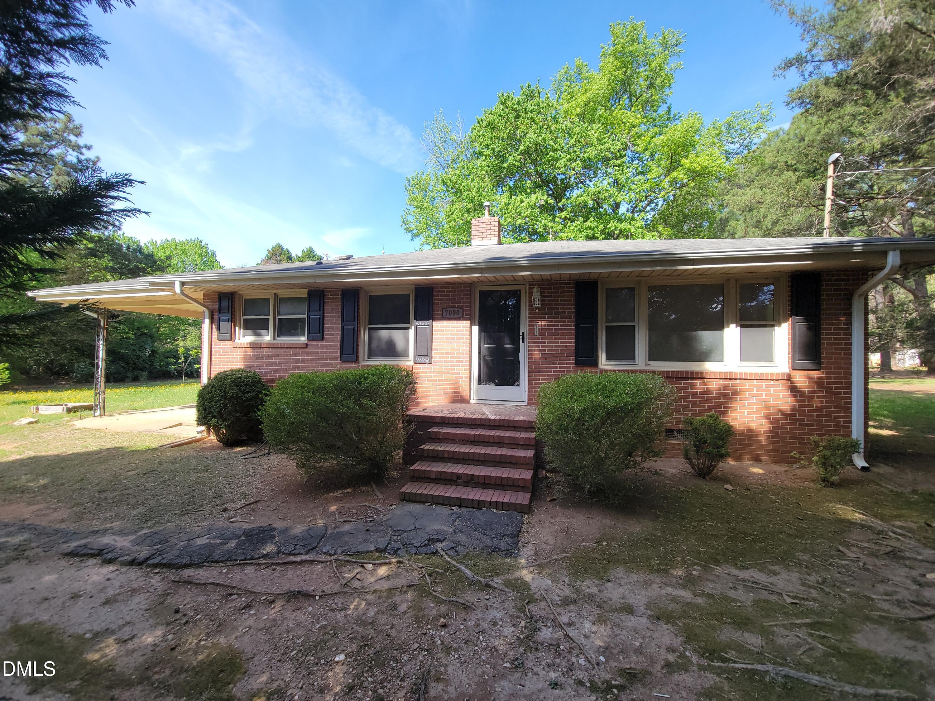 7000 Holly Springs Road Raleigh, NC 27606 - Photo 1 of 24 a view of a house with backyard and garden