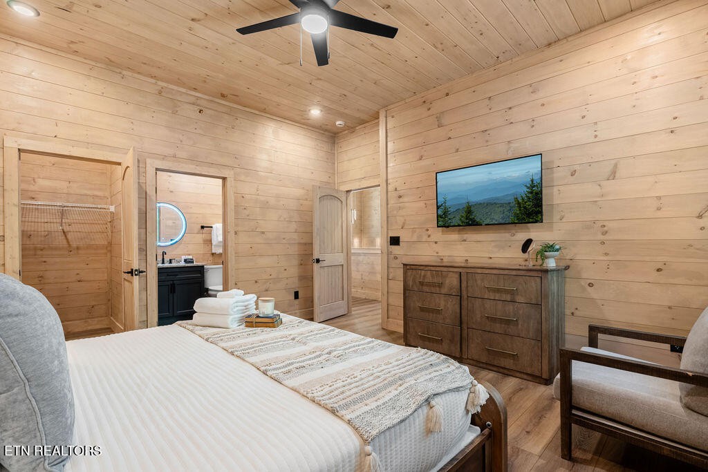 1620 Bear Valley Road Sevierville, TN 37876 - Photo 44 of 60 a bedroom with a bed and a flat screen tv