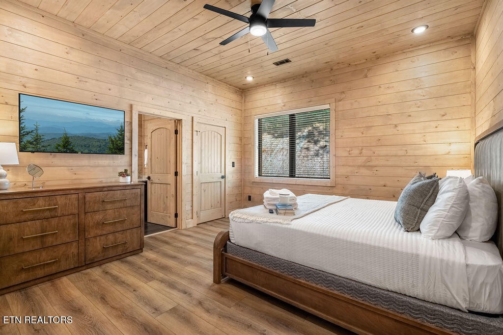 1620 Bear Valley Road Sevierville, TN 37876 - Photo 46 of 60 a bedroom with a bed and a flat screen tv
