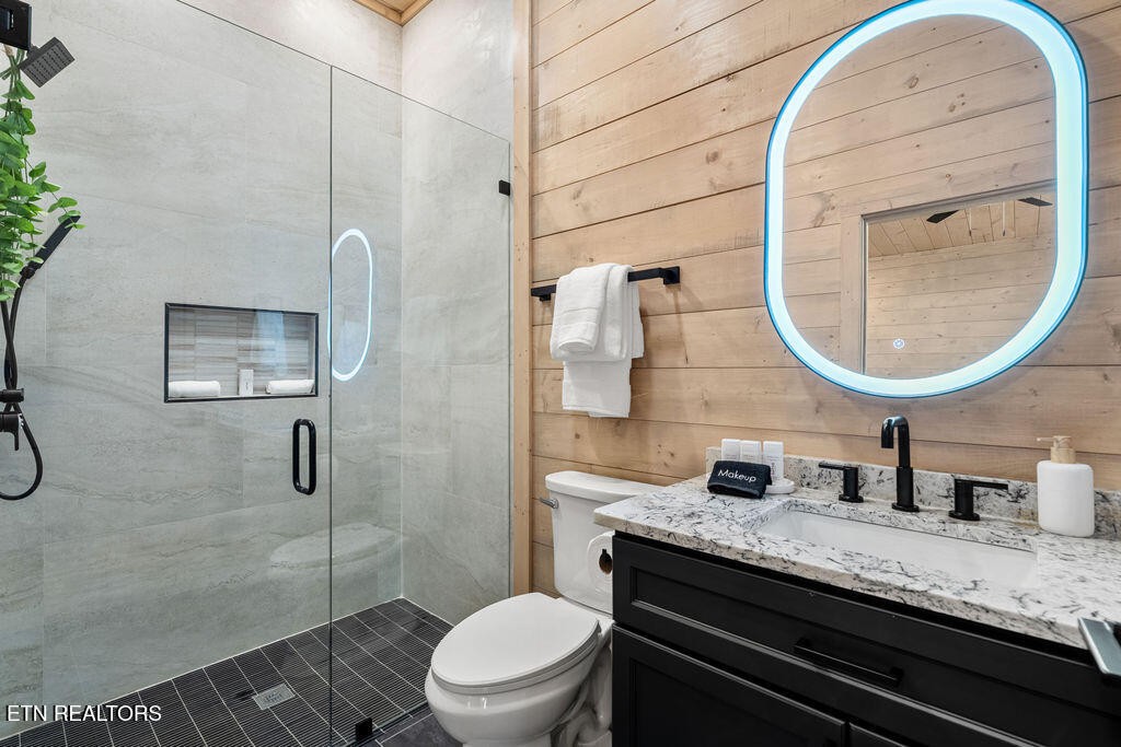 1620 Bear Valley Road Sevierville, TN 37876 - Photo 47 of 60 a bathroom with a granite countertop sink a mirror and a toilet