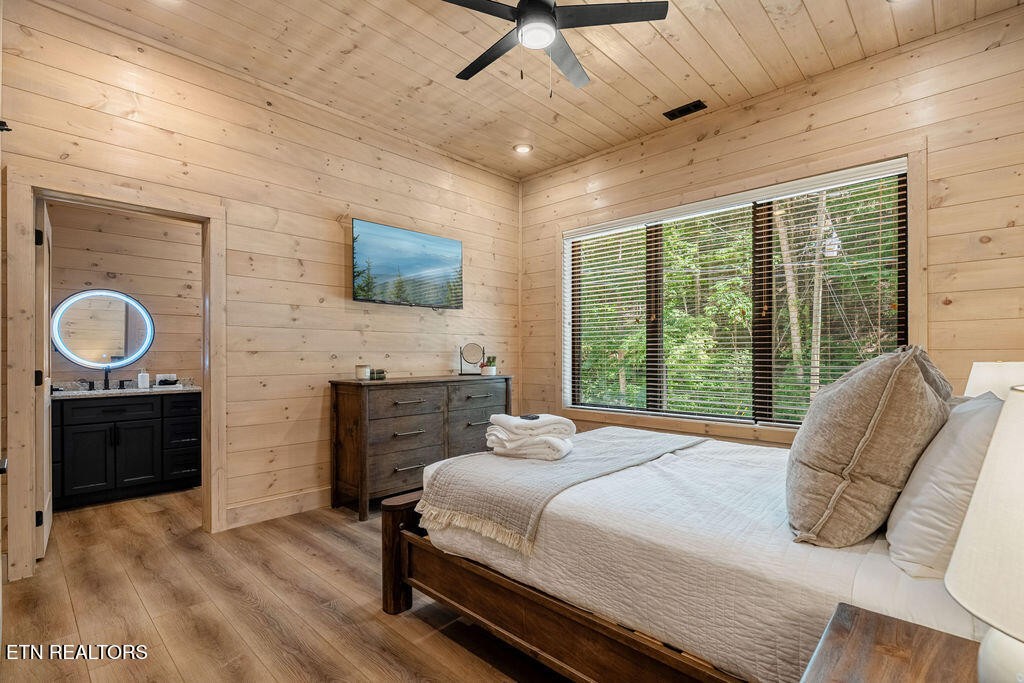1620 Bear Valley Road Sevierville, TN 37876 - Photo 54 of 60 a bedroom with a bed dresser and a flat tv screen