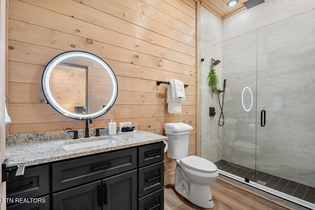 1620 Bear Valley Road Sevierville, TN 37876 - Photo 56 of 60 a bathroom with a granite countertop toilet sink mirror and shower
