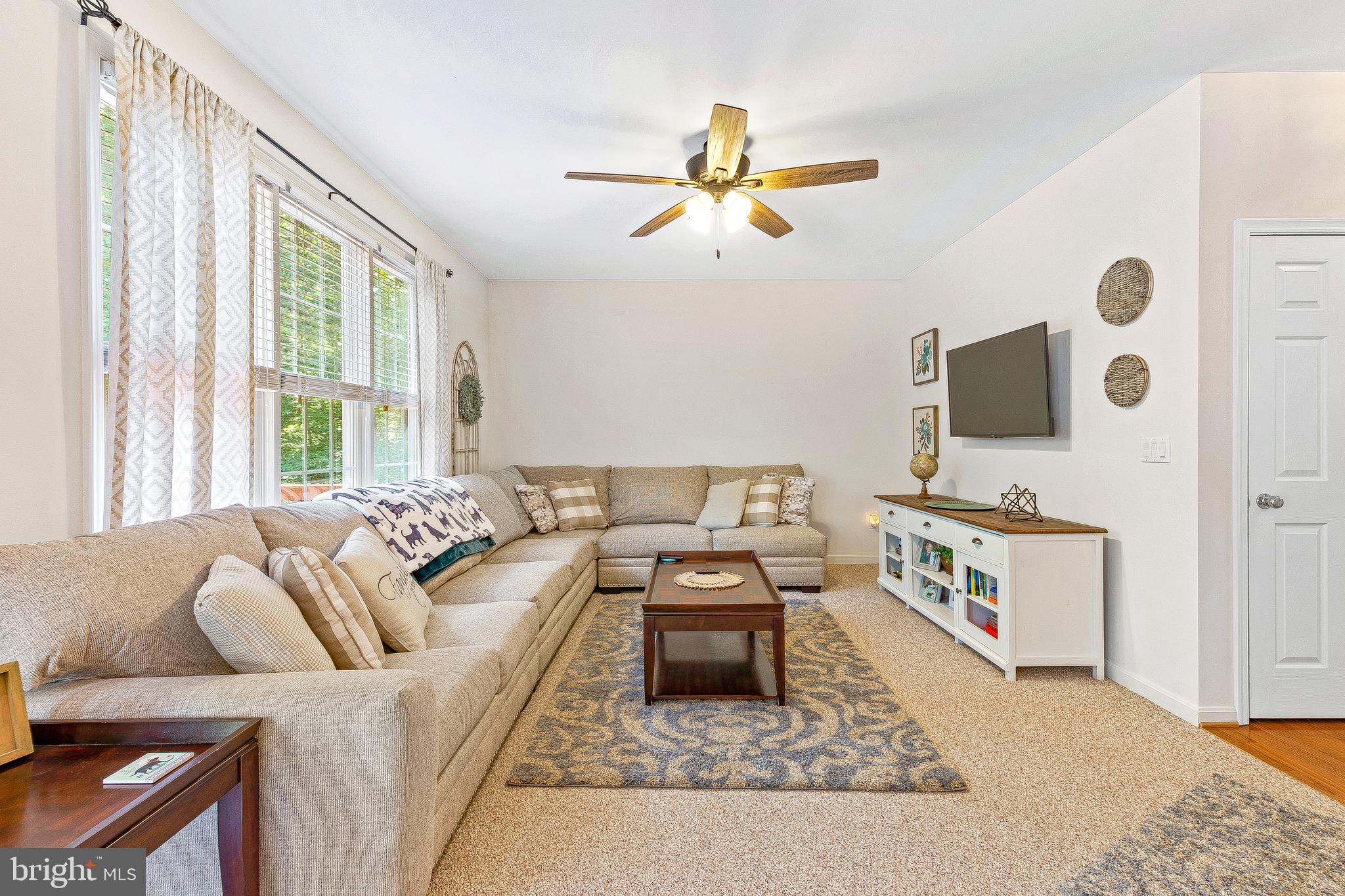 5270 Mackall Road St. Leonard, MD 20685 - Photo 11 of 42 a living room with furniture and a flat screen tv