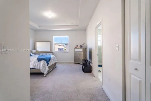 a bedroom with a bed and a tv on the dresser