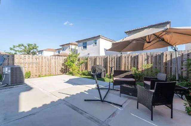 a swimming pool with yard and outdoor seating