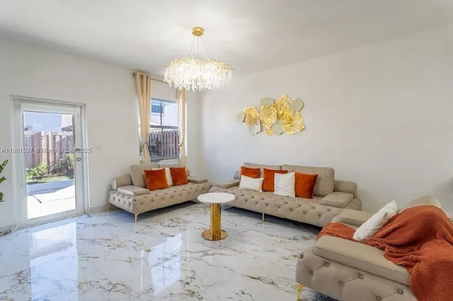 a living room with furniture and a chandelier