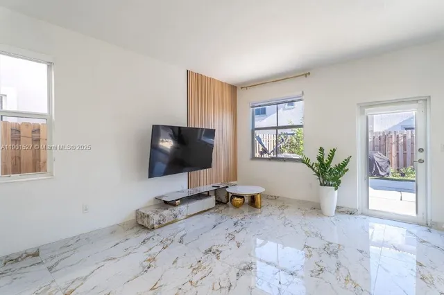 a view of a workspace with a window and potted plant