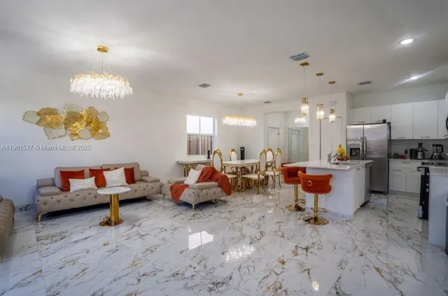 a living room with furniture and a kitchen view