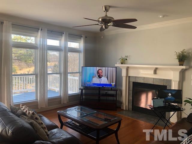 278 Waterville Street Raleigh, NC 27603 - Photo 3 of 7 a living room with furniture a window and a fireplace