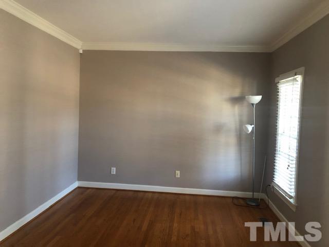 278 Waterville Street Raleigh, NC 27603 - Photo 6 of 7 an empty room with wooden floor and windows