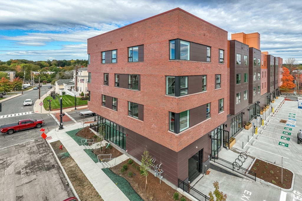 45 East Central Street, Unit 401 Natick, MA 01760 - Photo 13 of 16 a front view of a house with a yard