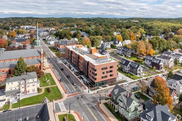 an aerial view of a residential apartment building with a yard
