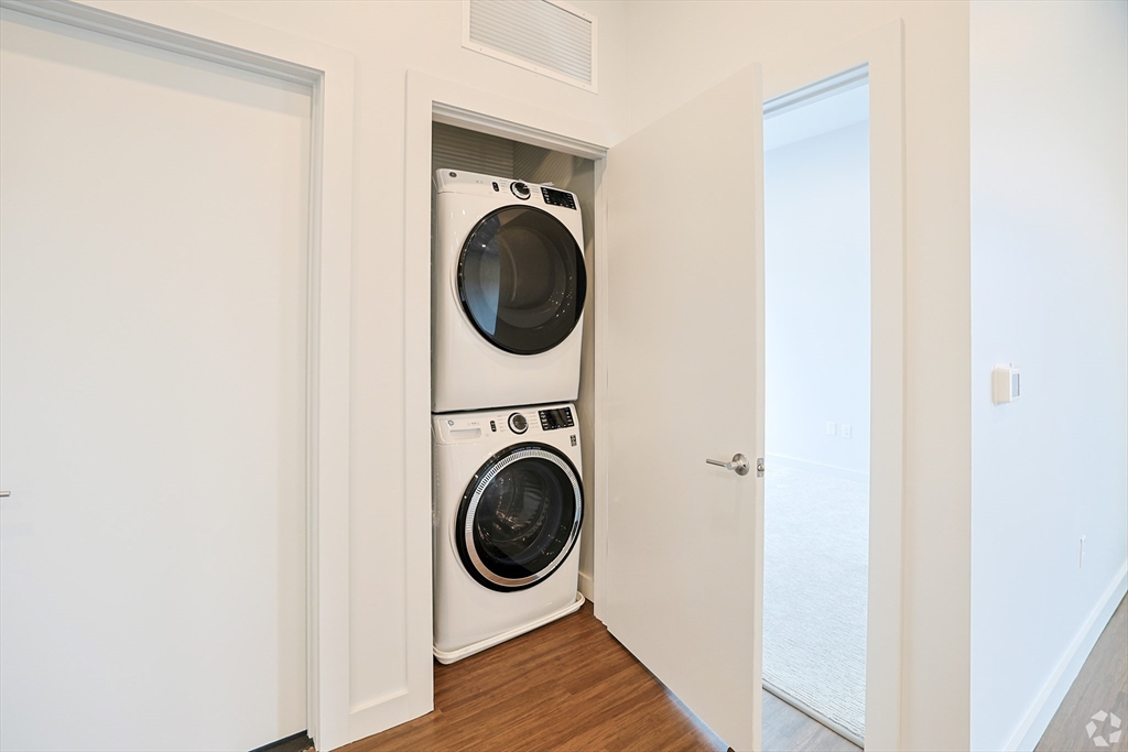 45 East Central Street, Unit 401 Natick, MA 01760 - Photo 4 of 16 a view of a hallway with washer and dryer