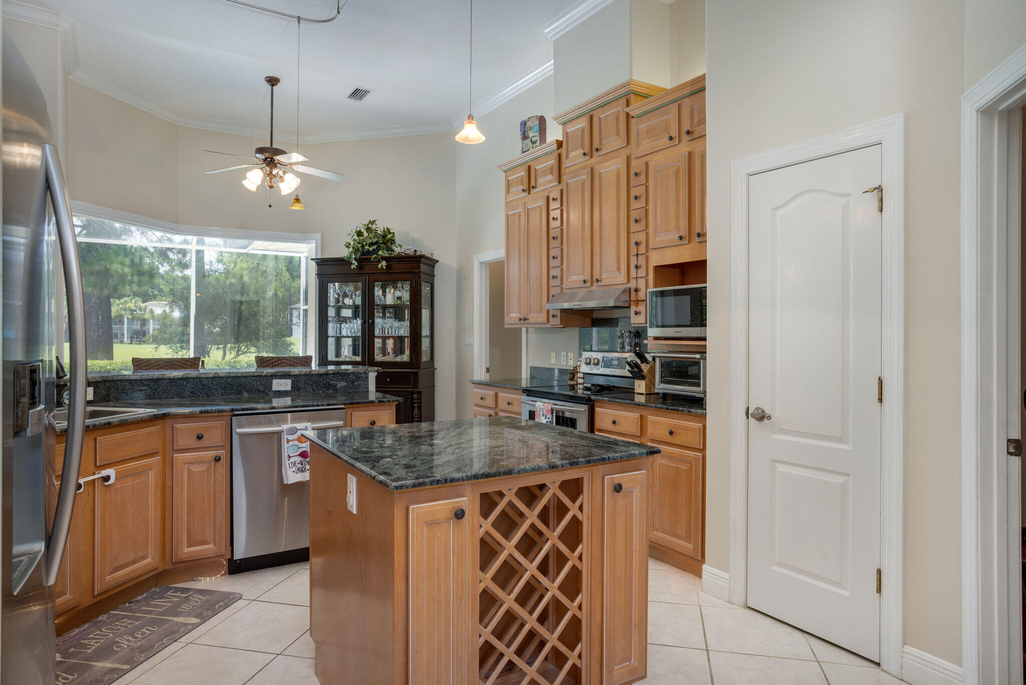 740 Indigo Loop Miramar Beach, FL 32550 - Photo 10 of 39 a kitchen with stainless steel appliances granite countertop a sink and a refrigerator