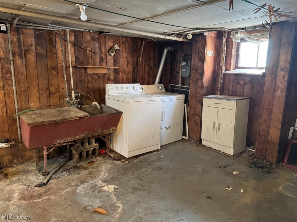 586 Brittain Road Akron, OH 44305 - Photo 13 of 19 Basement featuring separate washer and dryer, sink, and wood walls