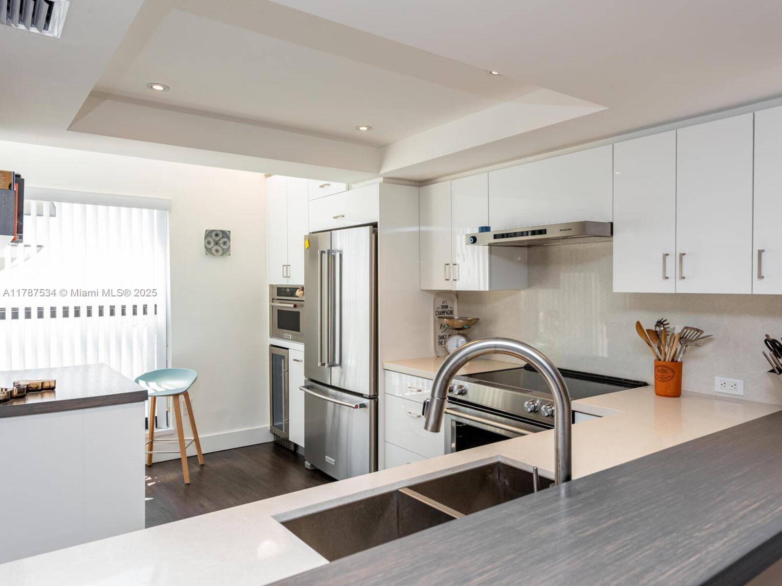 3229 Mary Street, Unit 2 Miami, FL 33133 - Photo 12 of 56 a kitchen with a refrigerator and a sink