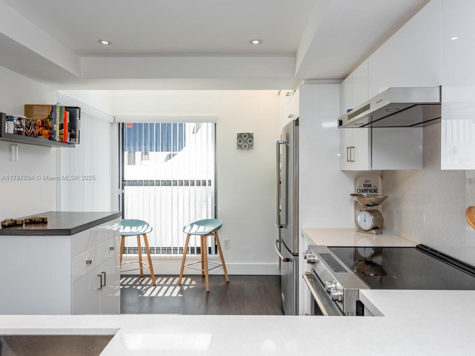 3229 Mary Street, Unit 2 Miami, FL 33133 - Photo 13 of 56 a kitchen with granite countertop a refrigerator and a sink