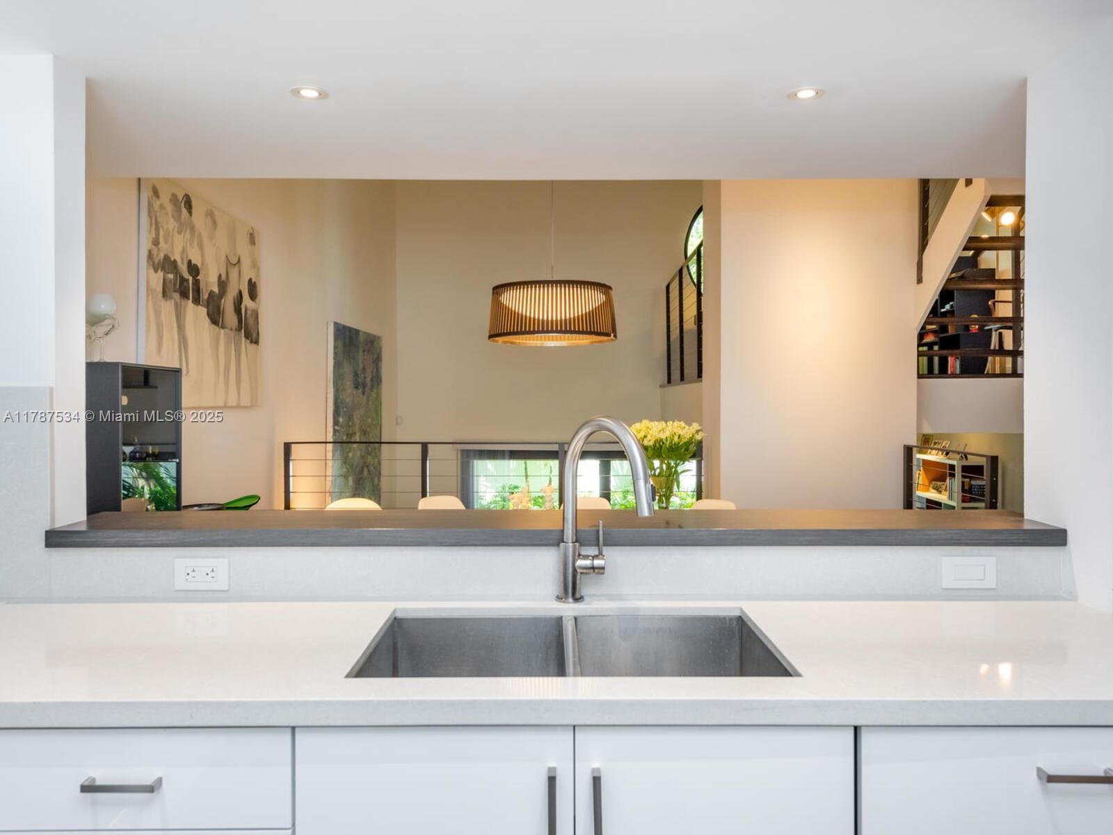 3229 Mary Street, Unit 2 Miami, FL 33133 - Photo 16 of 56 a kitchen with a sink and a mirror