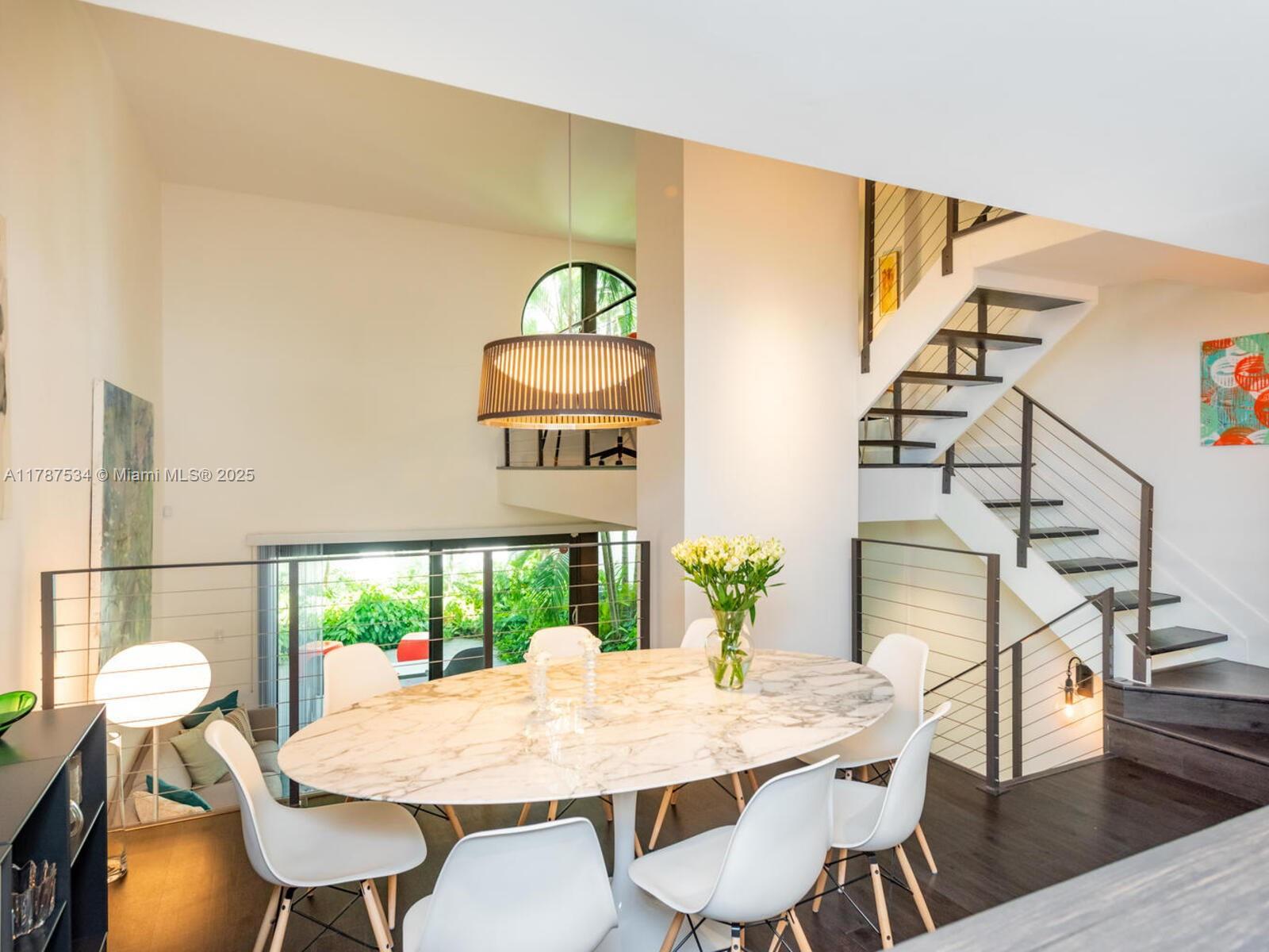 3229 Mary Street, Unit 2 Miami, FL 33133 - Photo 17 of 56 a view of a dining room with furniture window and wooden floor