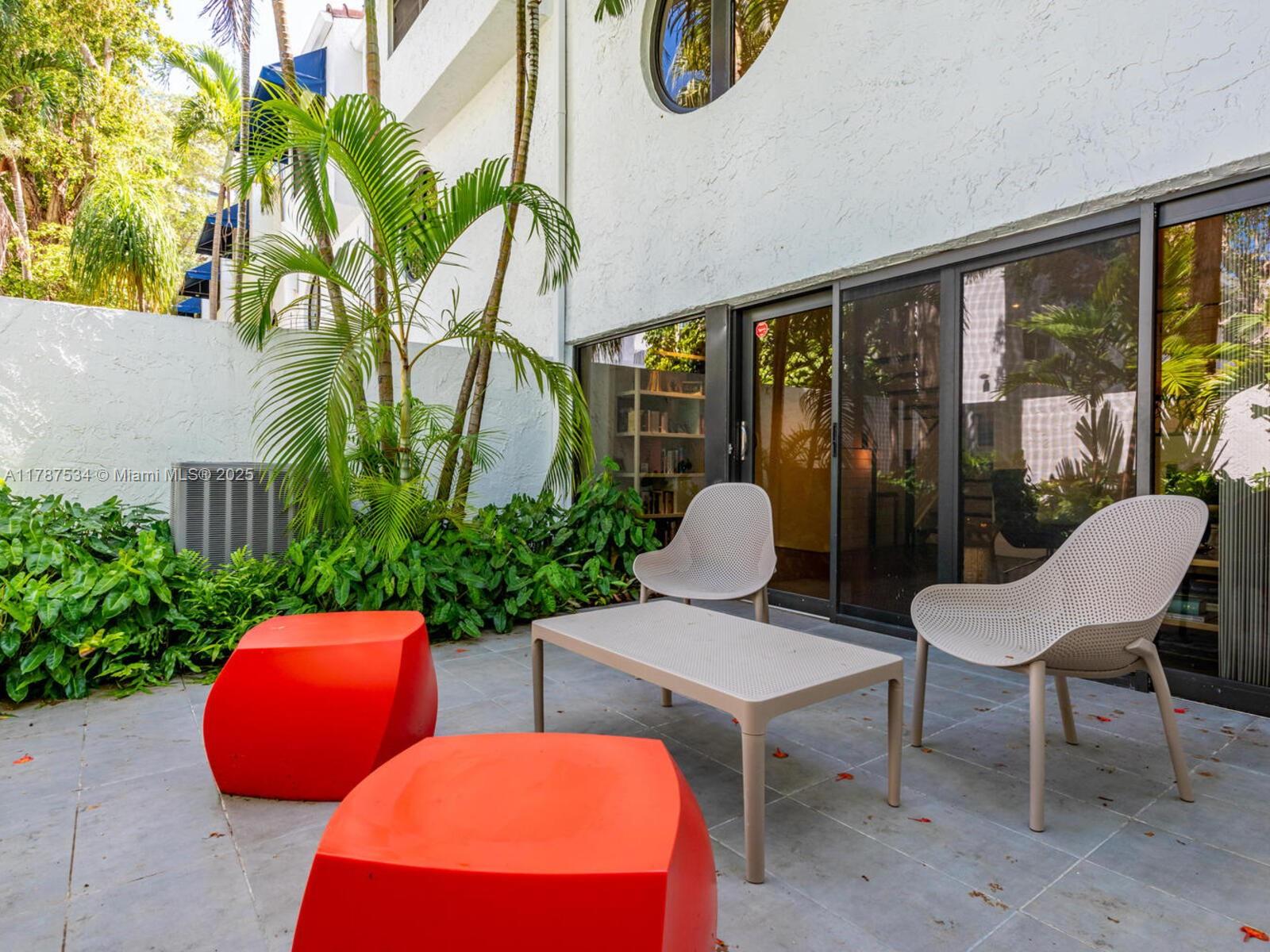 3229 Mary Street, Unit 2 Miami, FL 33133 - Photo 30 of 56 a view of a patio with couple of chairs and potted plants