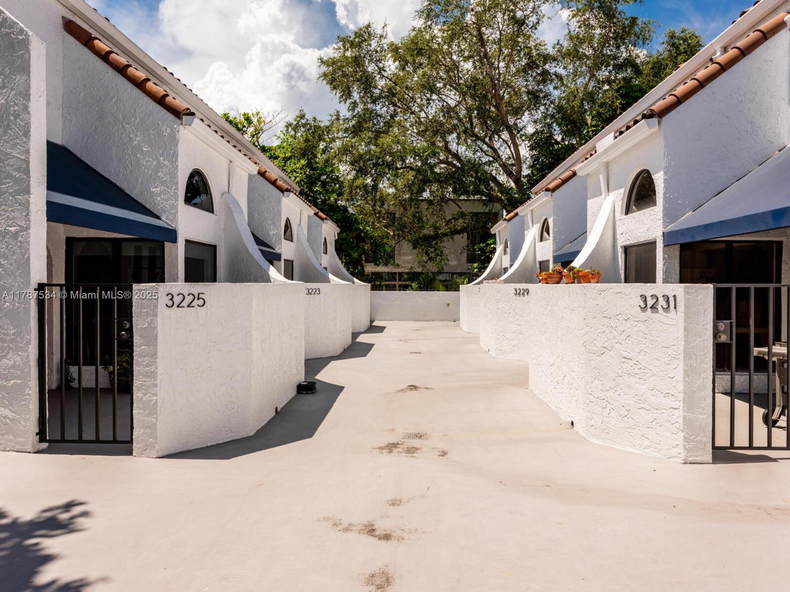 3229 Mary Street, Unit 2 Miami, FL 33133 - Photo 4 of 56 a view of a white house with snow on the road