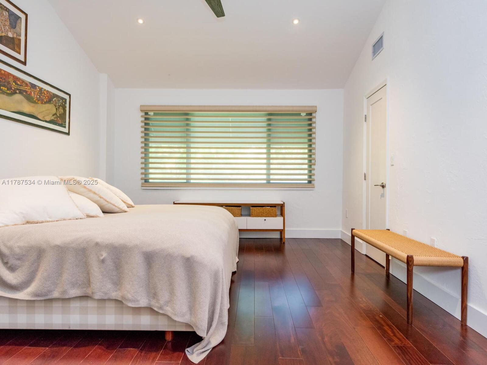 3229 Mary Street, Unit 2 Miami, FL 33133 - Photo 48 of 56 a bedroom with a bed and a chair