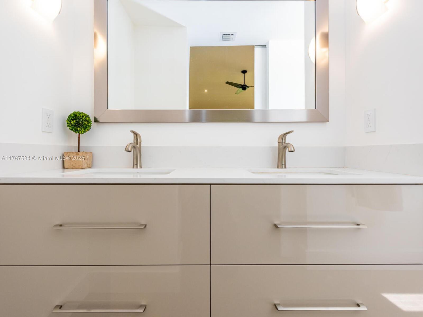 3229 Mary Street, Unit 2 Miami, FL 33133 - Photo 50 of 56 a bathroom with a sink and a mirror