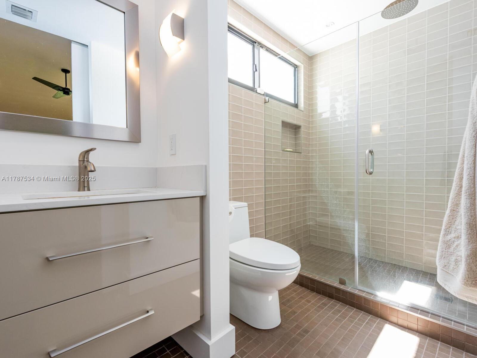 3229 Mary Street, Unit 2 Miami, FL 33133 - Photo 51 of 56 a bathroom with a sink a toilet and shower