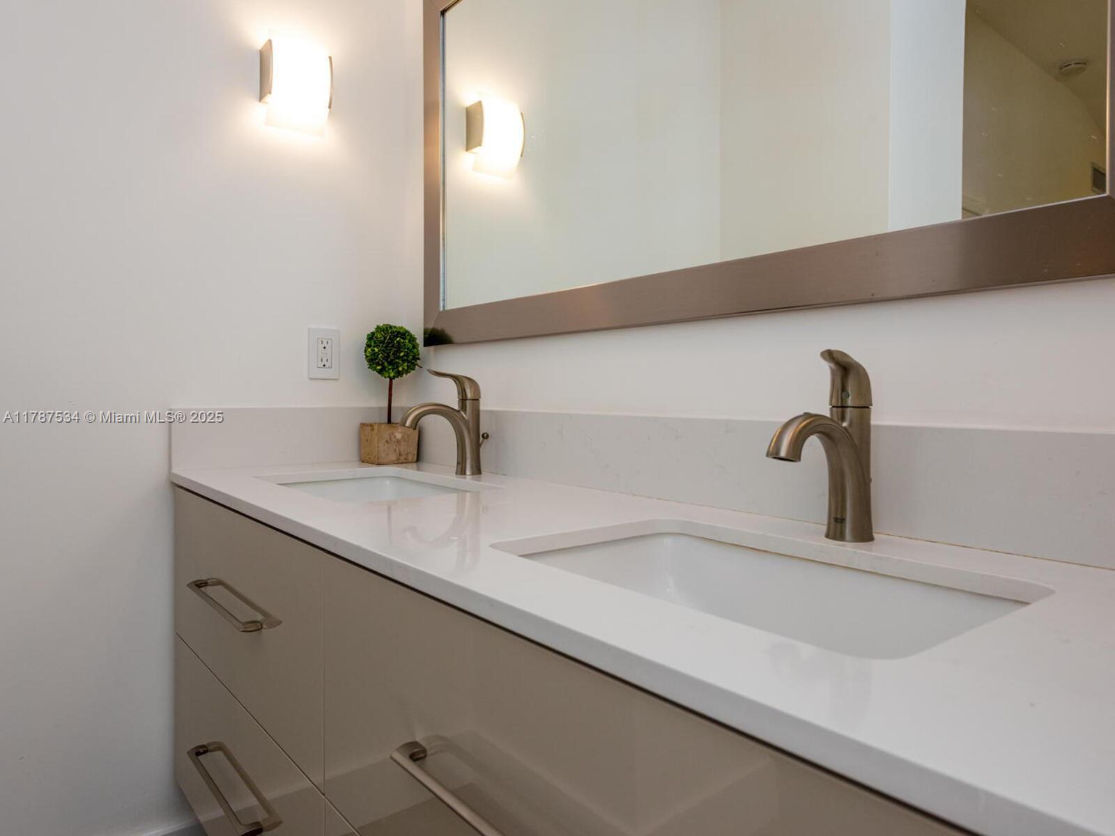 3229 Mary Street, Unit 2 Miami, FL 33133 - Photo 53 of 56 a bathroom with a sink and a mirror