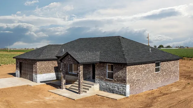 a terrace of a house with barbeque oven in front of house