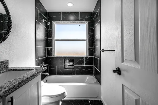 an empty room with a window and a ceiling fan