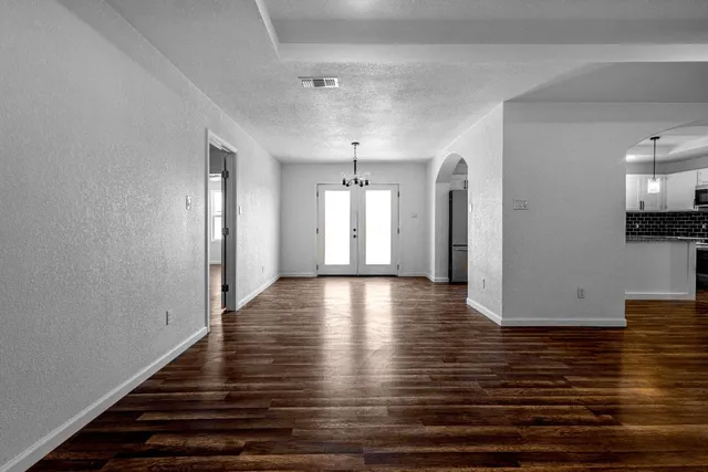 a view of a room with wooden floor and staircase