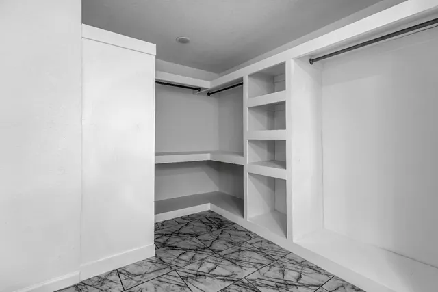 a white toilet sitting next to a shower