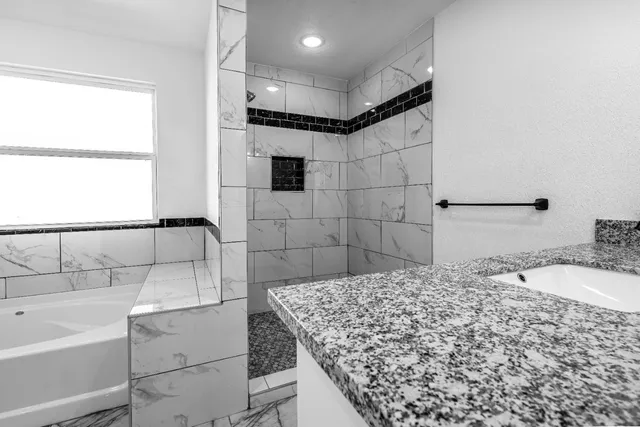 an empty room with wooden floor and a ceiling fan