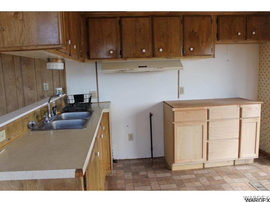 3596 Magma Road Golden Valley, AZ 86413 - Photo 5 of 21 a kitchen with a sink cabinets and wooden floor