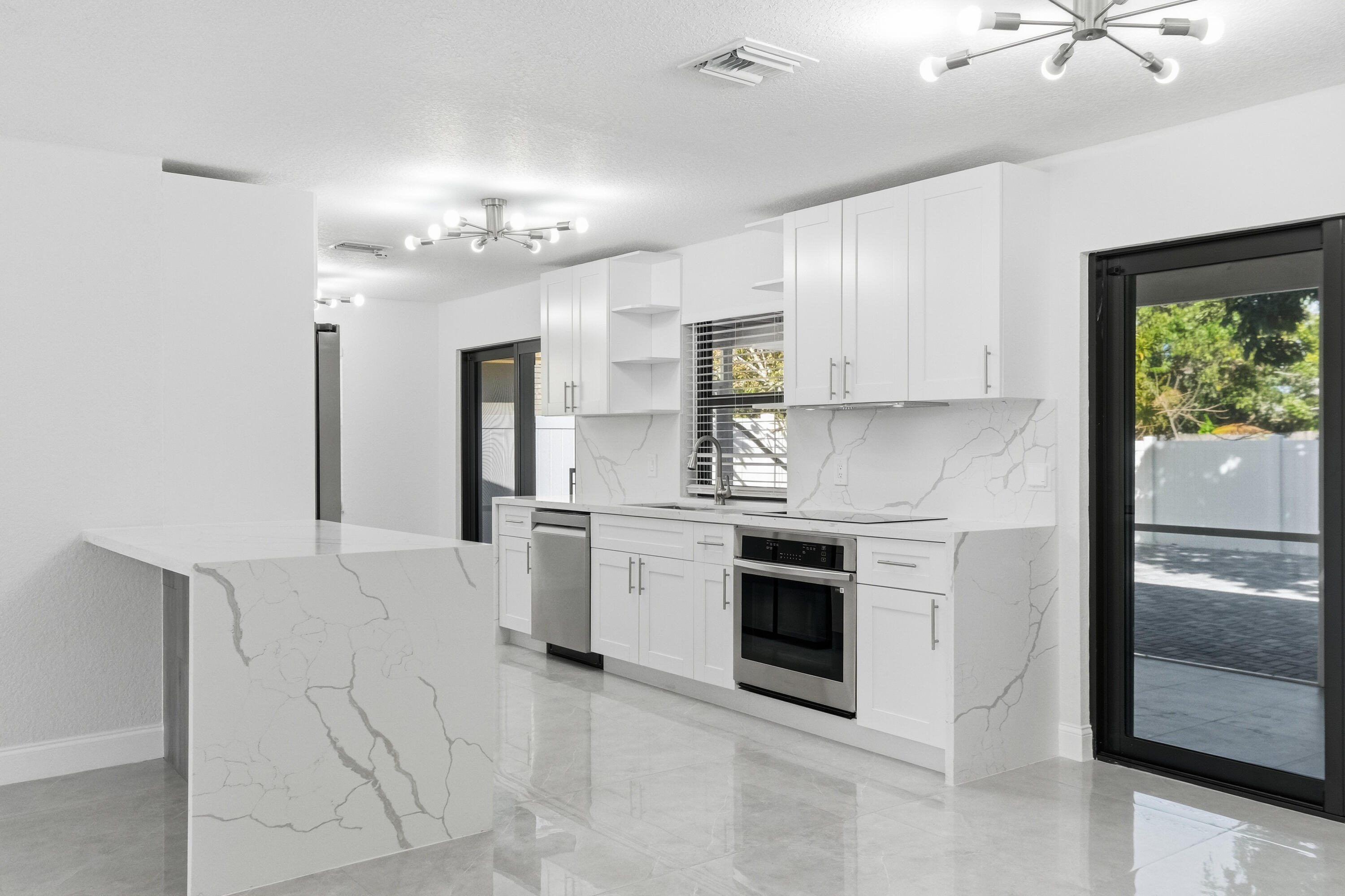 22390 Southwest 66th Avenue Boca Raton, FL 33428 - Photo 16 of 58 a kitchen with cabinets and stainless steel appliances