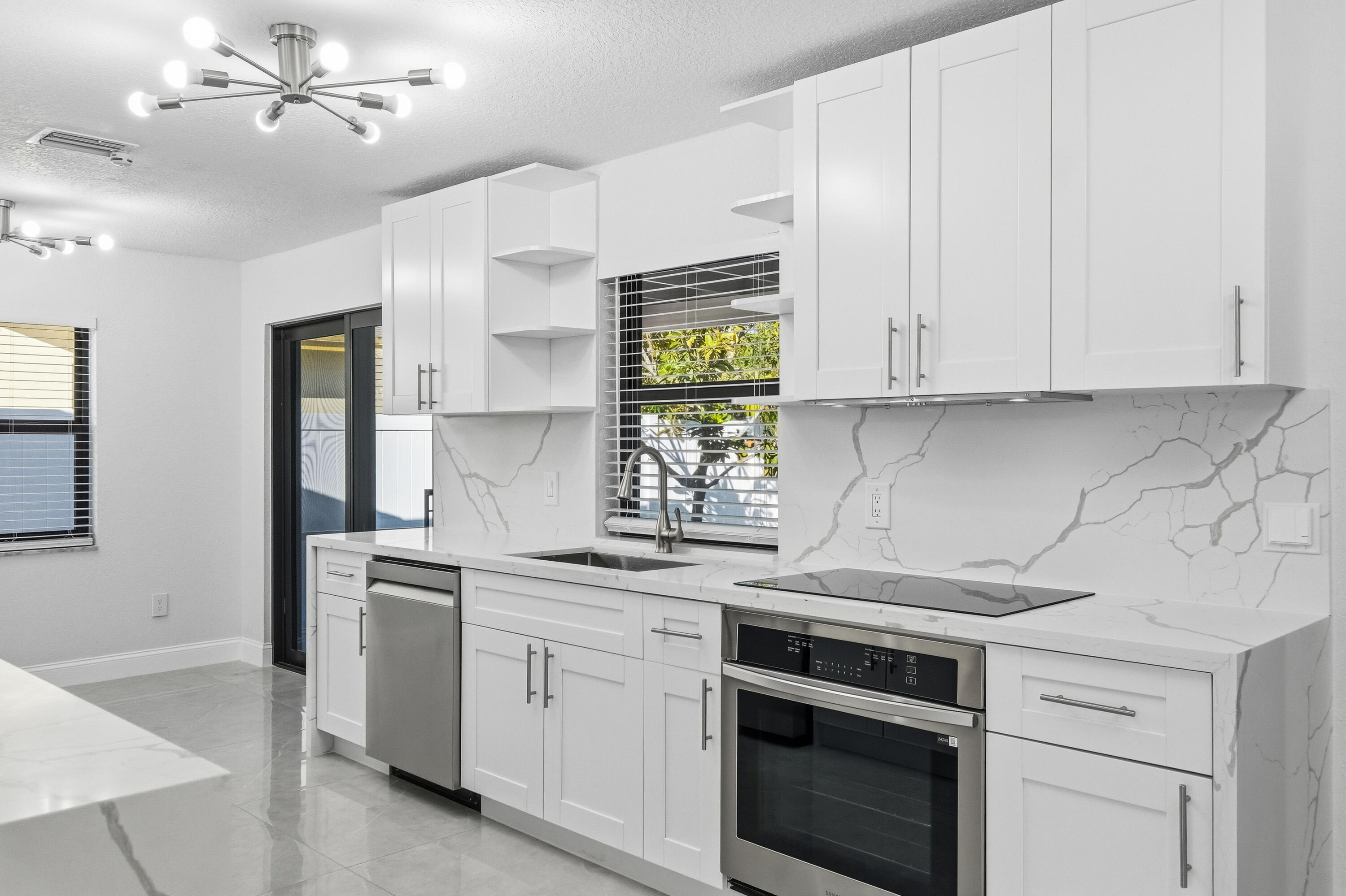 22390 Southwest 66th Avenue Boca Raton, FL 33428 - Photo 18 of 58 a kitchen with appliances cabinets and a sink