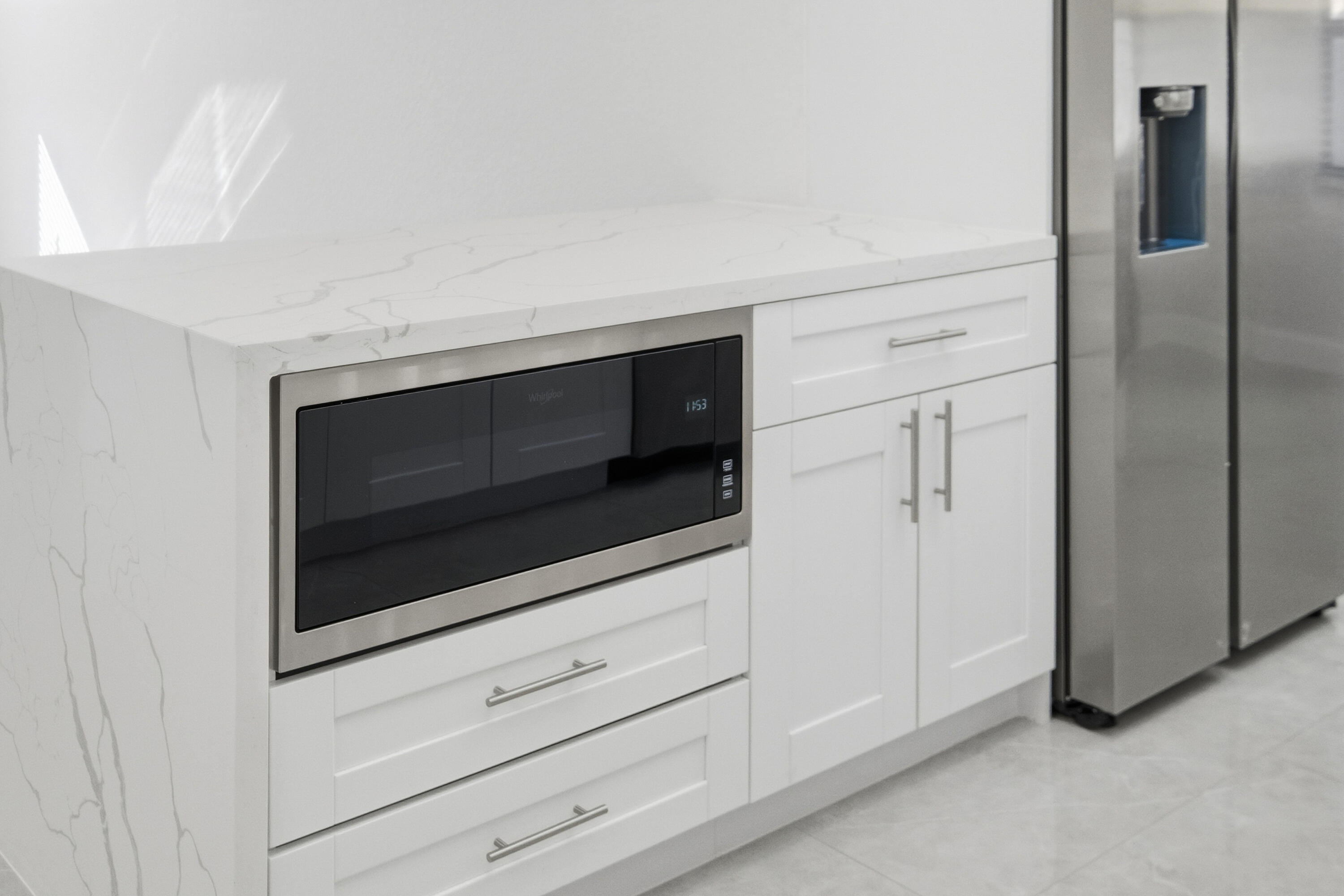22390 Southwest 66th Avenue Boca Raton, FL 33428 - Photo 20 of 58 a kitchen with white cabinets and stainless steel appliances