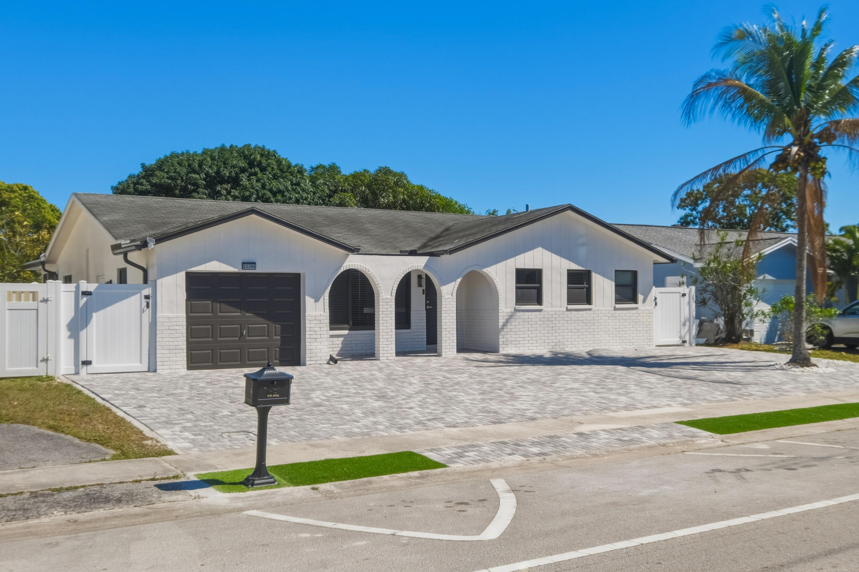 22390 Southwest 66th Avenue Boca Raton, FL 33428 - Photo 2 of 58 a front view of a house with garden