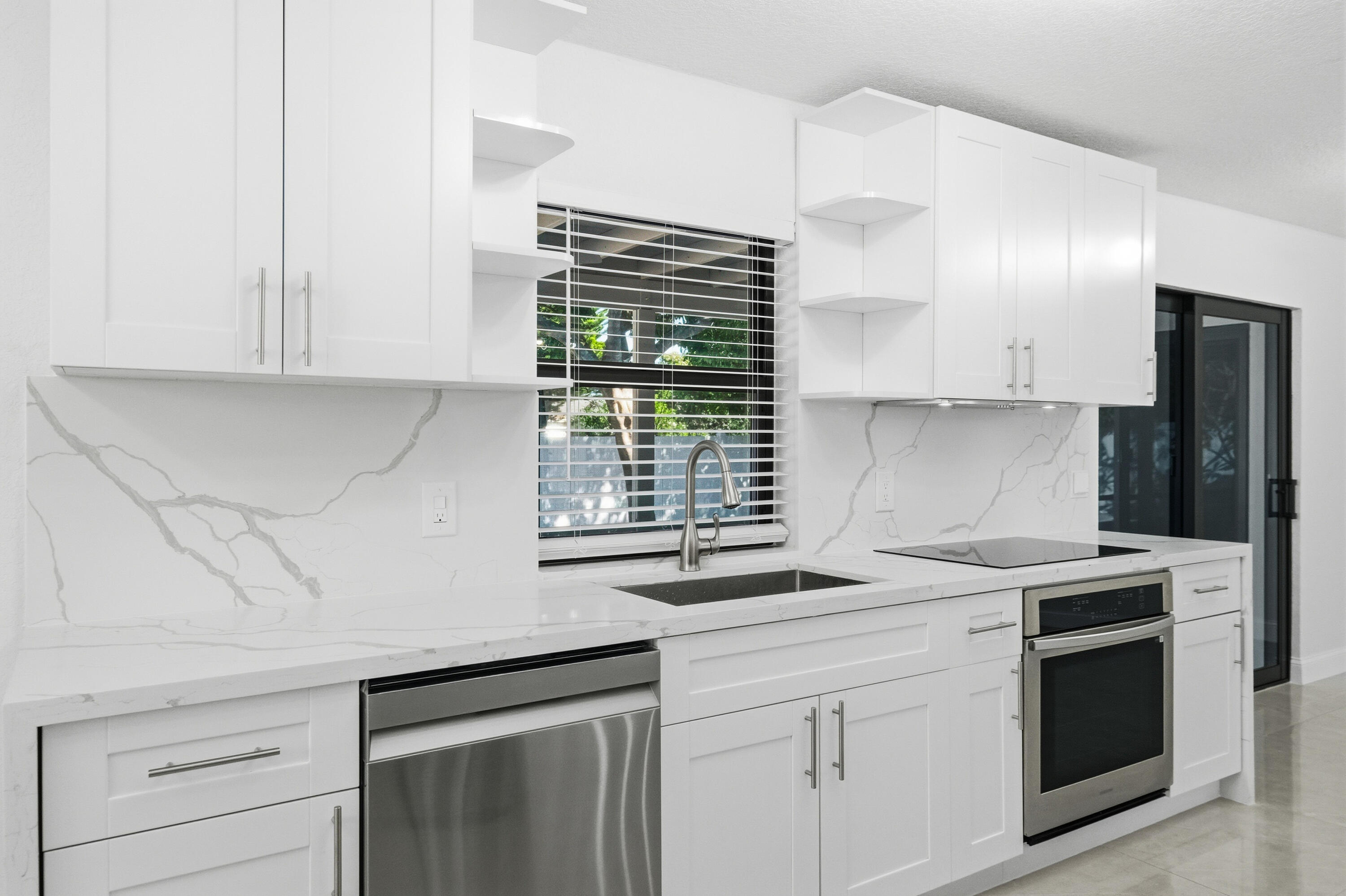 22390 Southwest 66th Avenue Boca Raton, FL 33428 - Photo 21 of 58 a kitchen with granite countertop white cabinets and white appliances