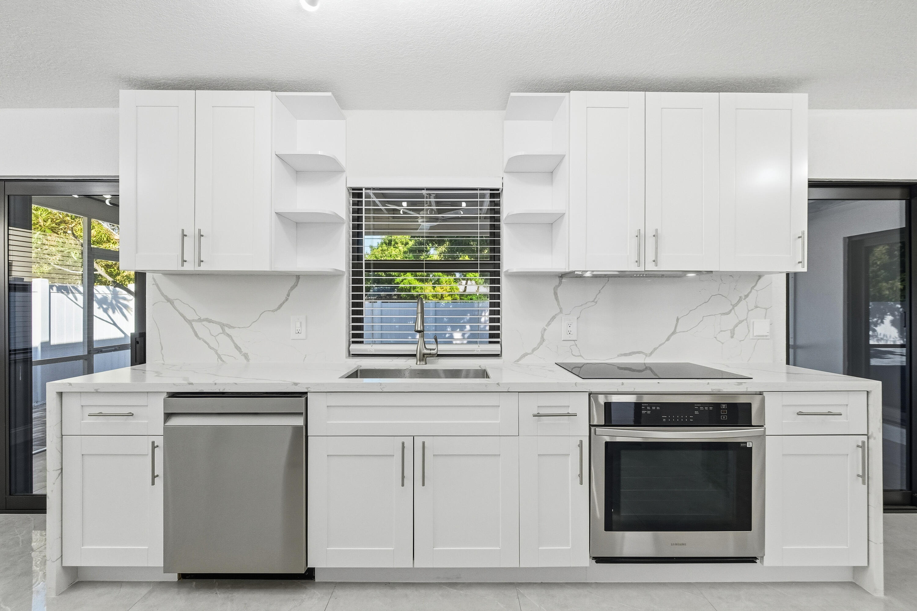 22390 Southwest 66th Avenue Boca Raton, FL 33428 - Photo 22 of 58 a kitchen with white cabinets and appliances
