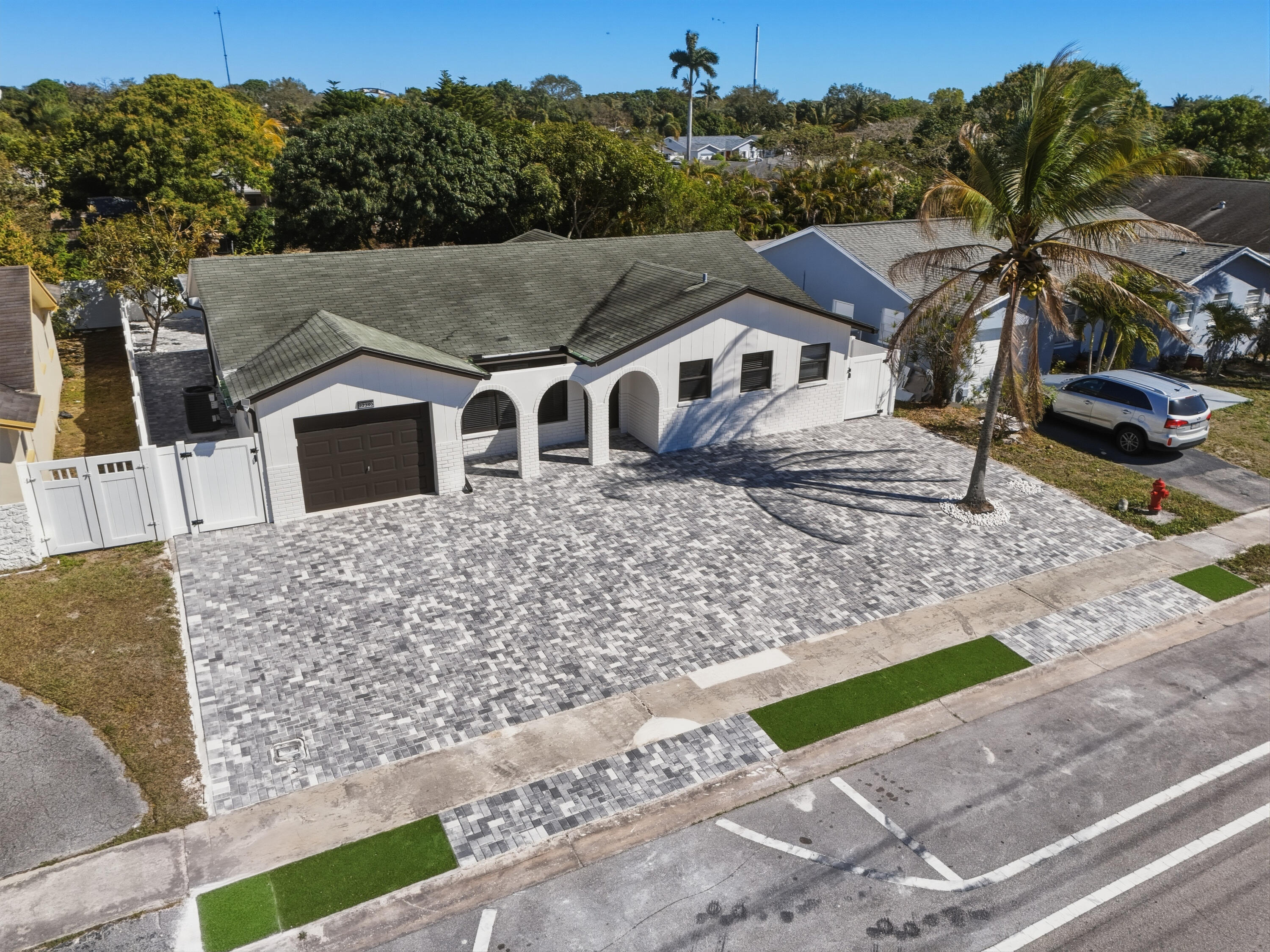 22390 Southwest 66th Avenue Boca Raton, FL 33428 - Photo 4 of 58 a front view of a house with a yard and mountain view in back