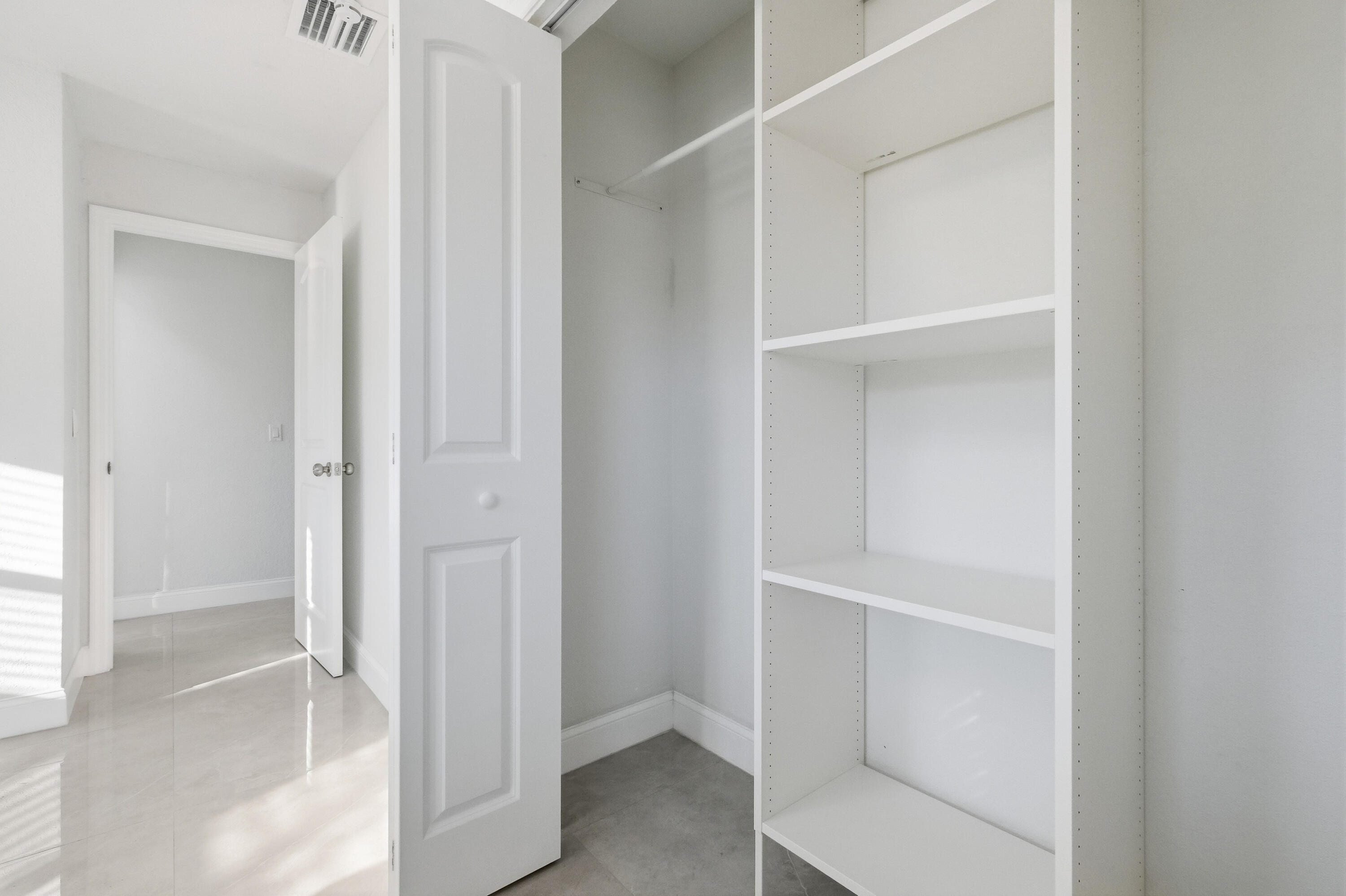 22390 Southwest 66th Avenue Boca Raton, FL 33428 - Photo 41 of 58 a view of an empty walk in closet