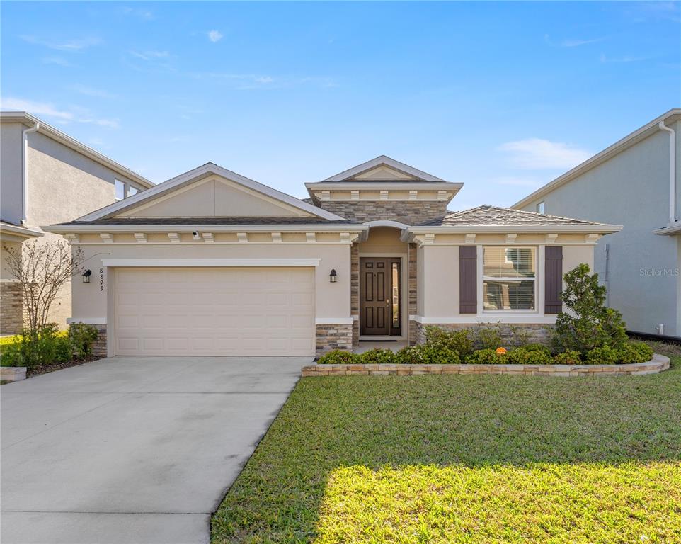 8899 Southwest 50th Avenue Ocala, FL 34476 - Photo 1 of 1 a front view of a house with a yard