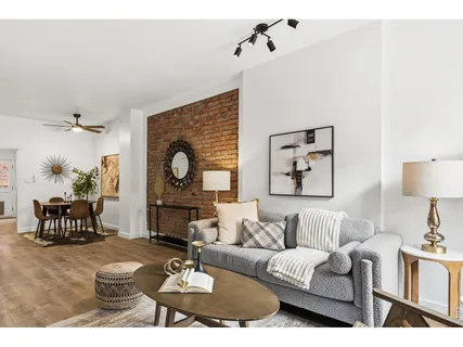 a living room with furniture a fireplace and a table