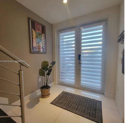 a spacious bedroom with a bed and large windows