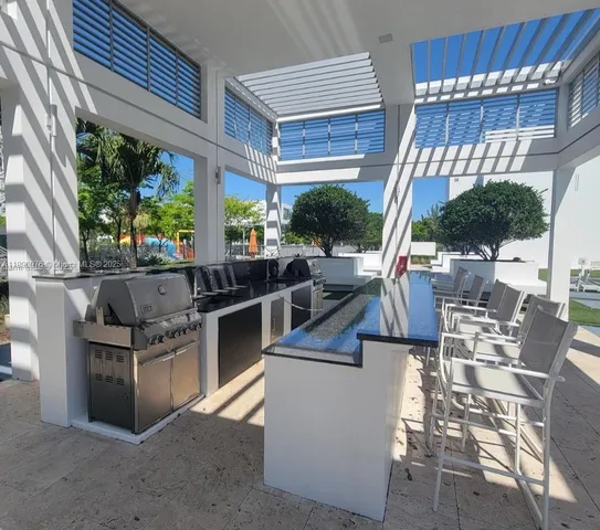 a kitchen with a refrigerator and a sink