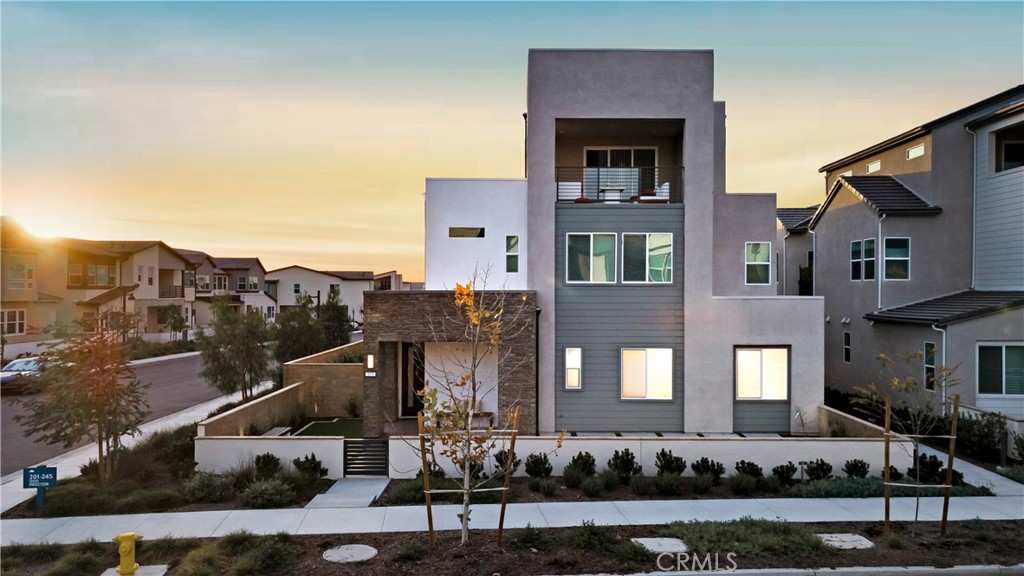 a front view of a residential apartment building with a yard